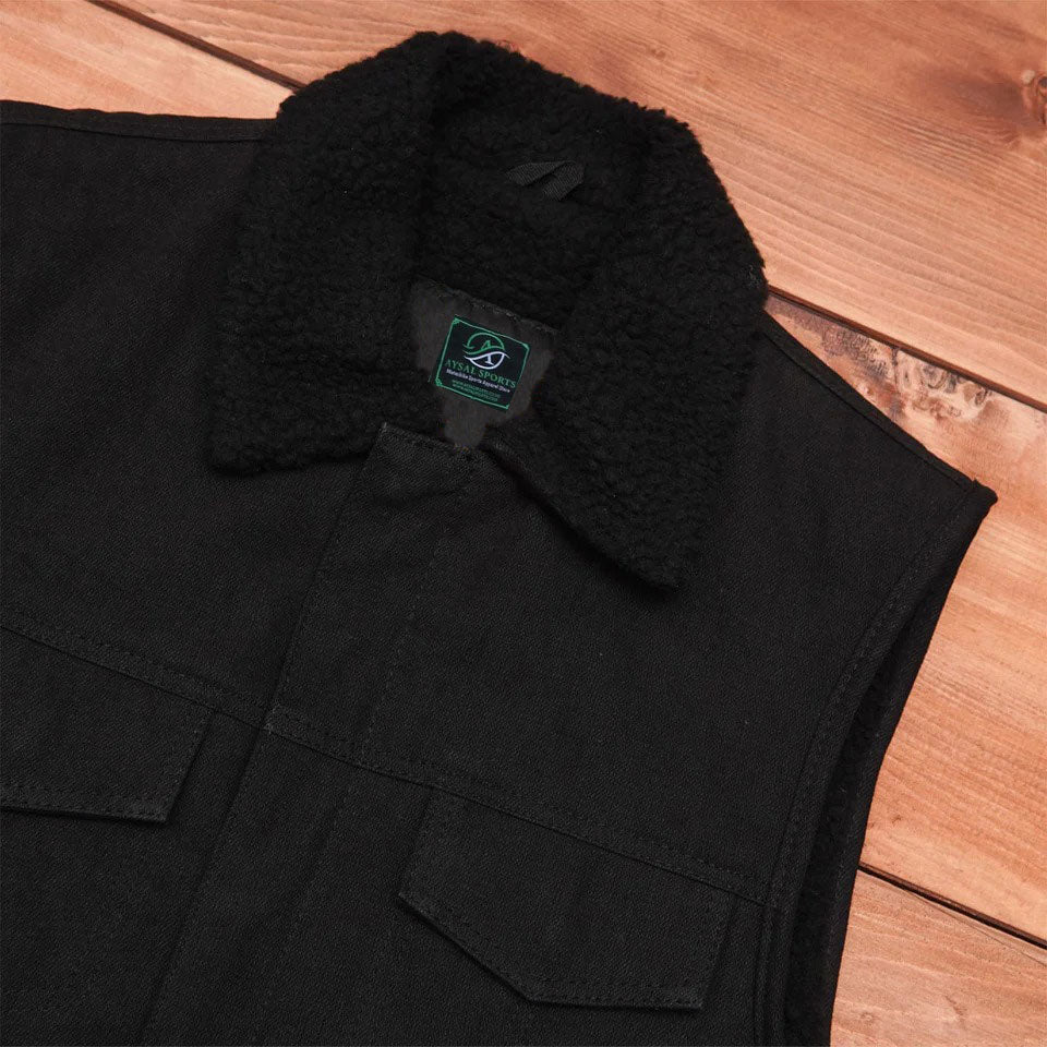 Black jacket with a fur-lined collar on a wooden surface