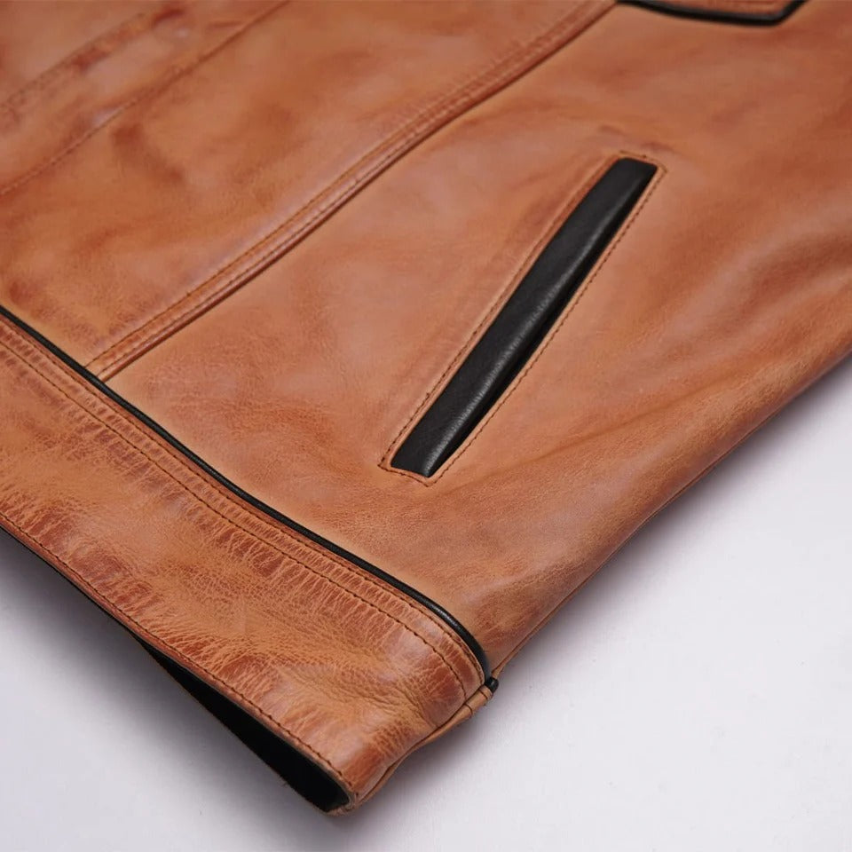 Close-up of a brown leather jacket with a pocket