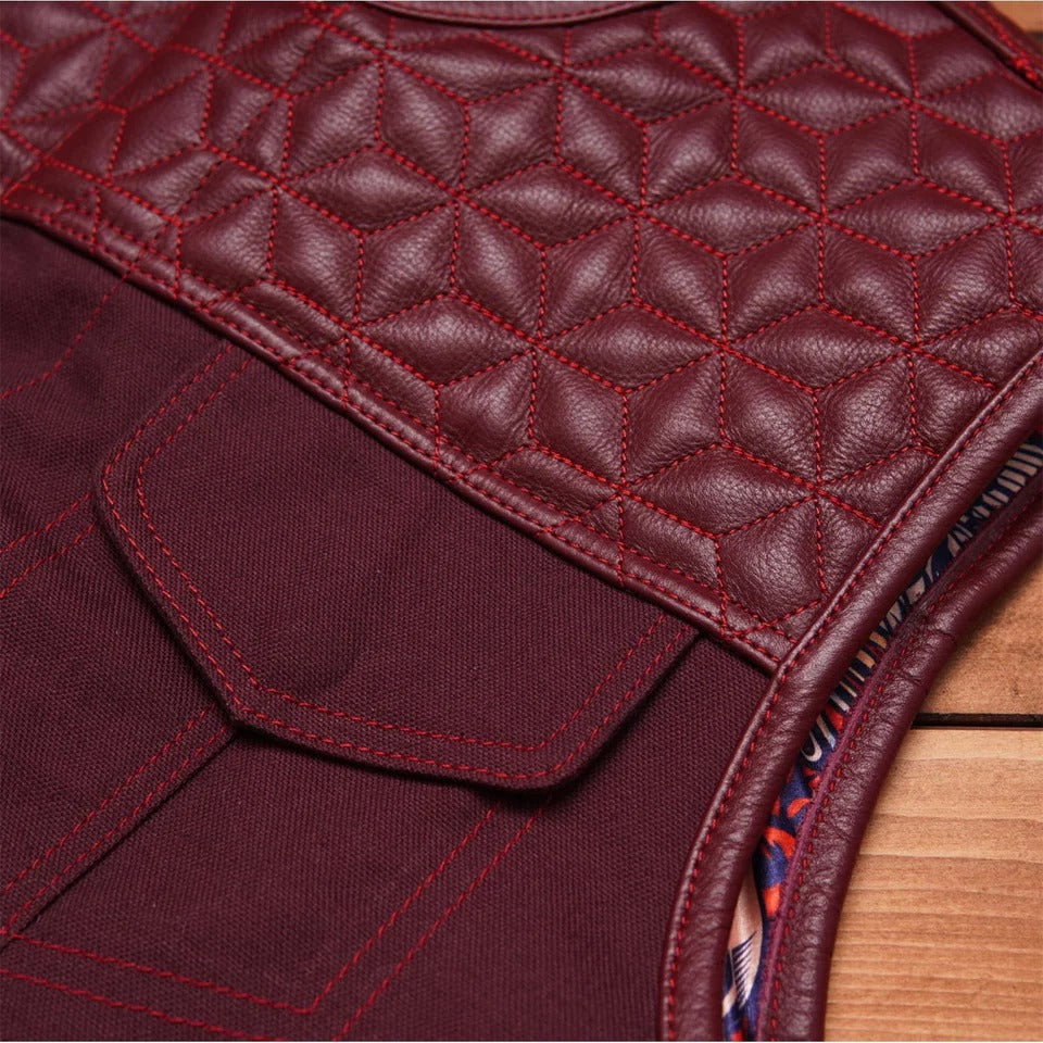 Close-up of a maroon quilted leather bag with red