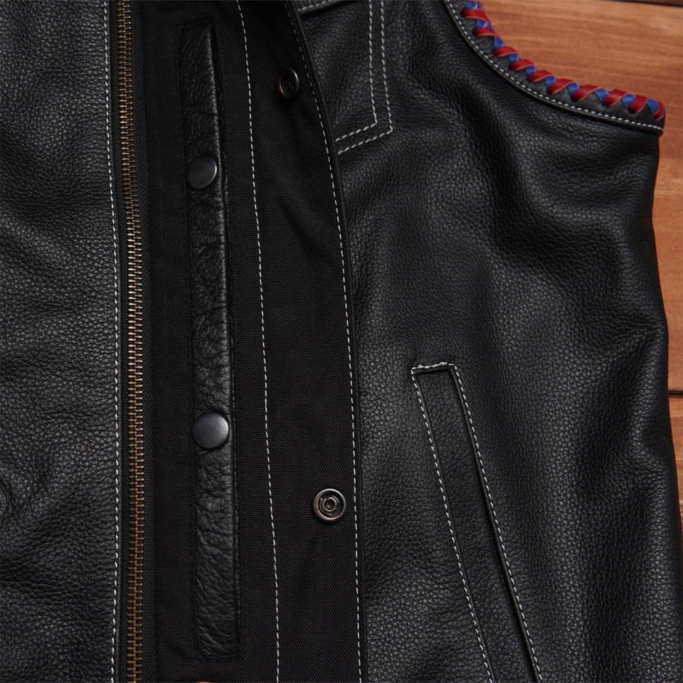 Close-up of a black leather jacket with red and blue stitching 