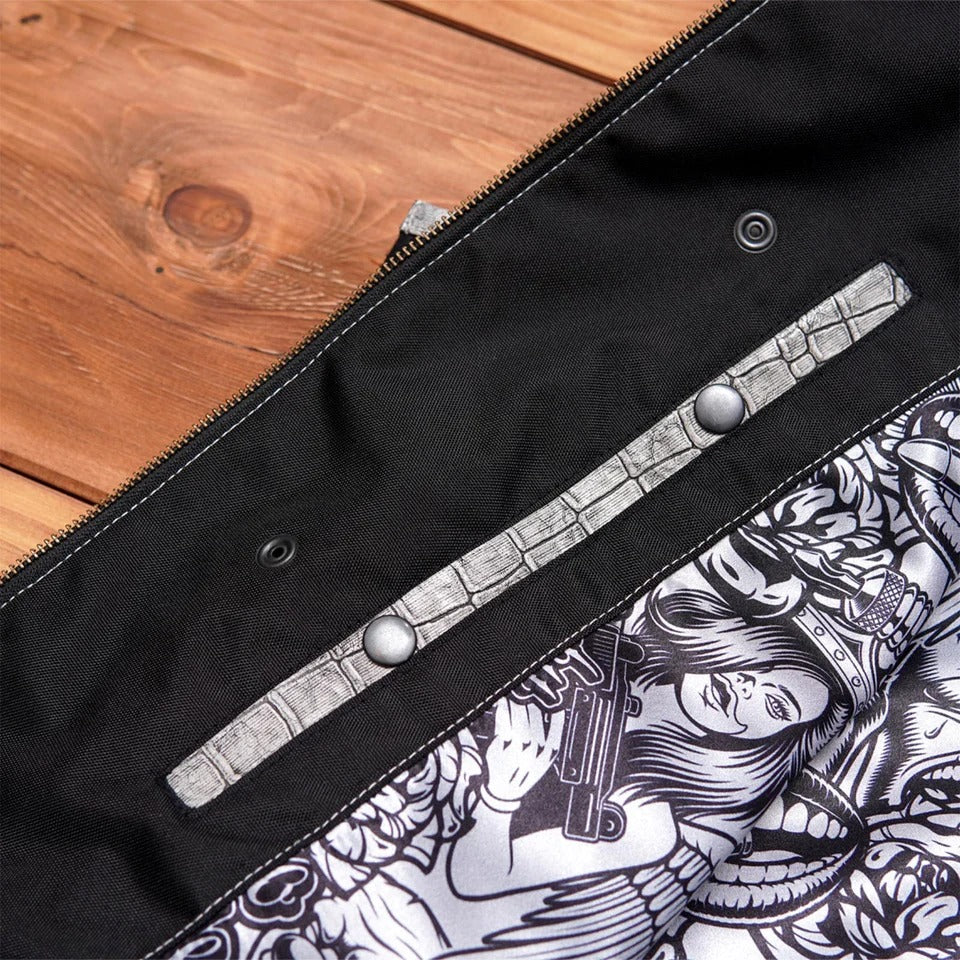 Close-up of a black bag with white and gray patterned interior
