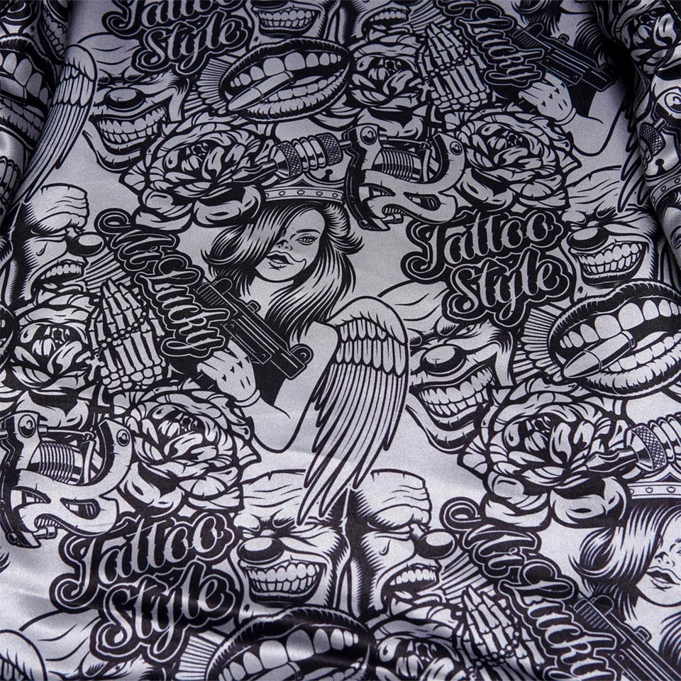 Black and white tattoo-style design with angel, roses, and text on a textured fabric background.
